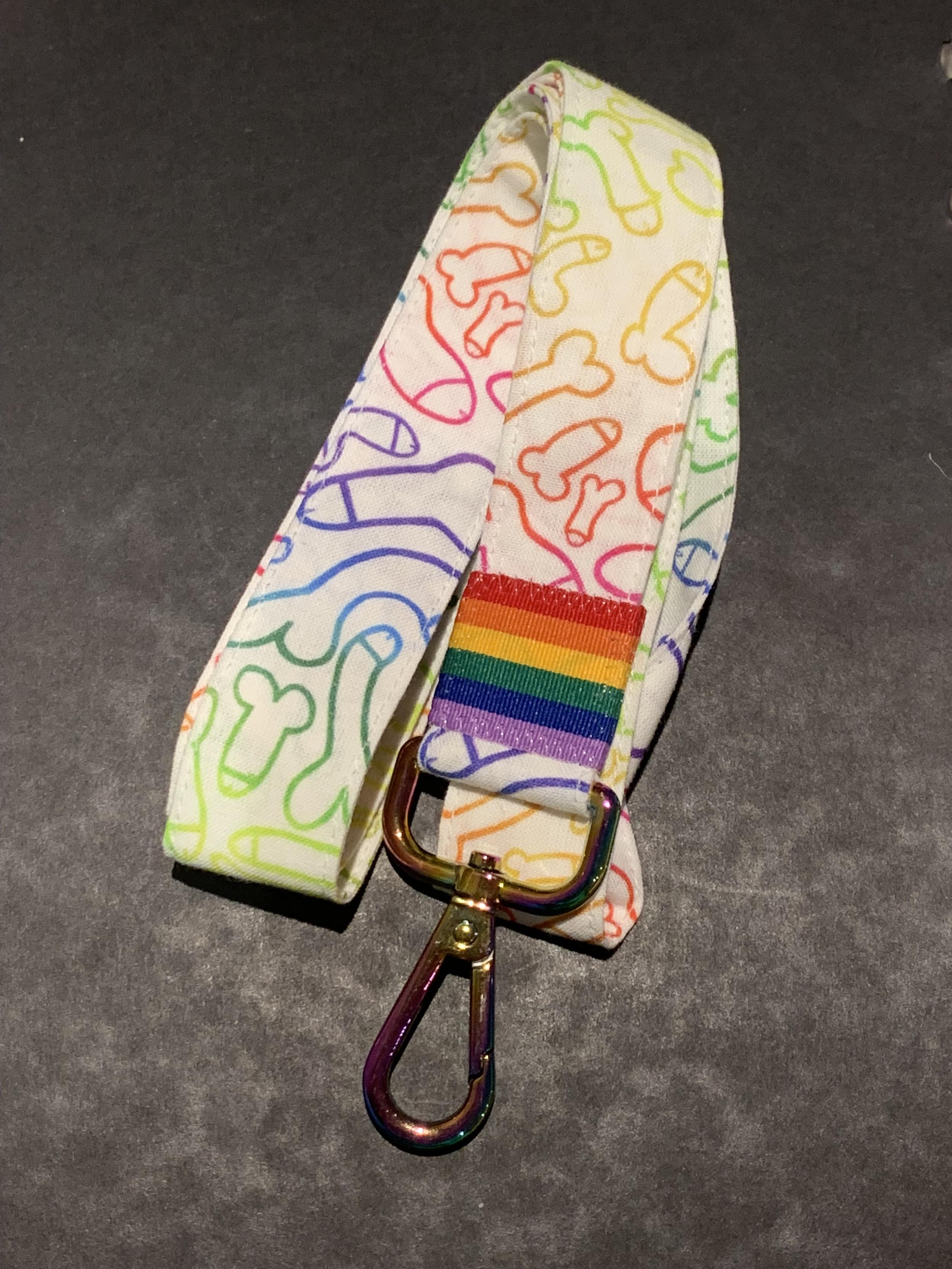 A lanyard with a rainbow flag on it made out of rainbow penis fabric
